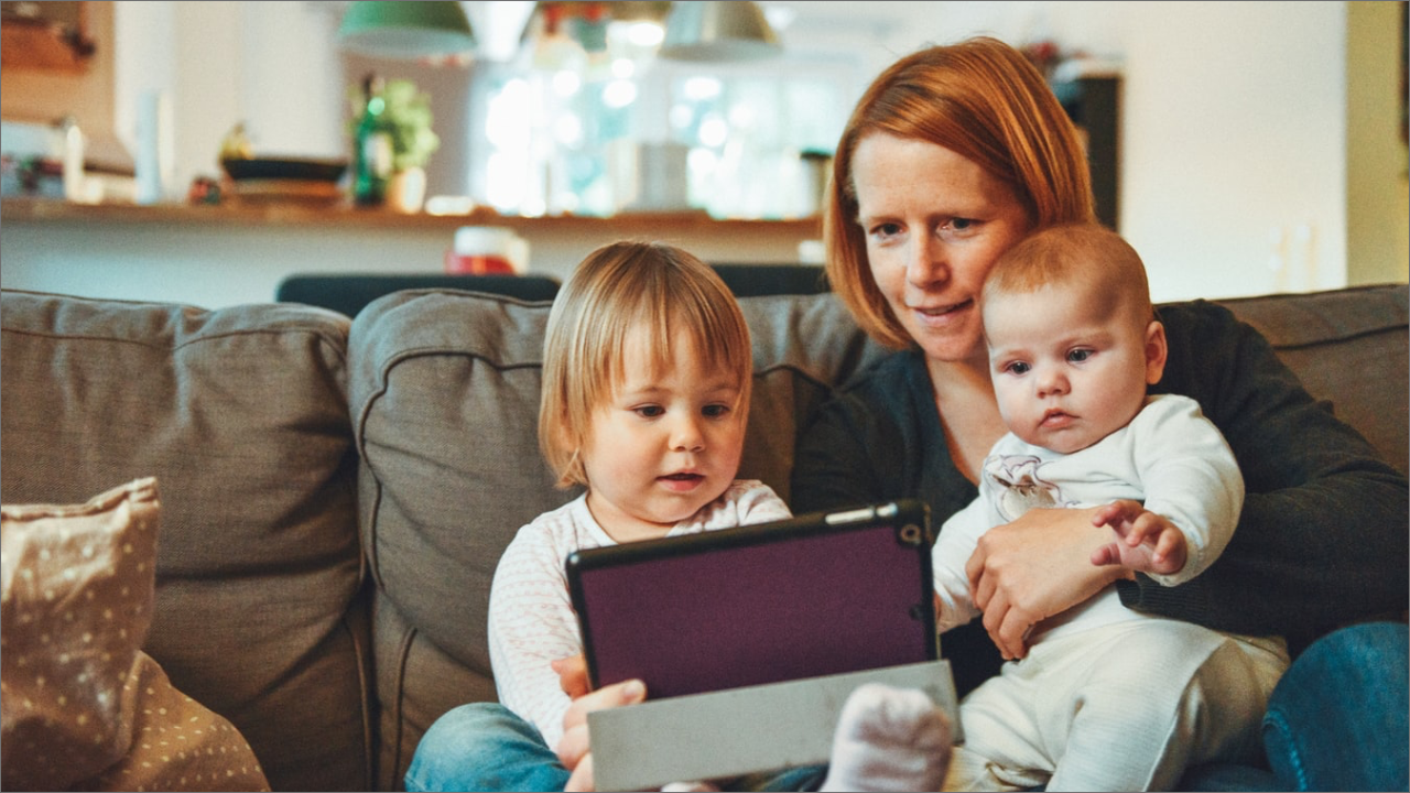 mom with two babies using a tablet