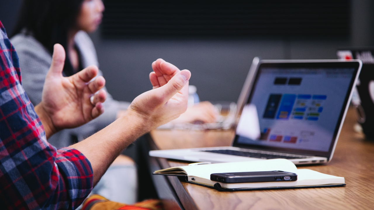 Hands trying to explain things with a laptop