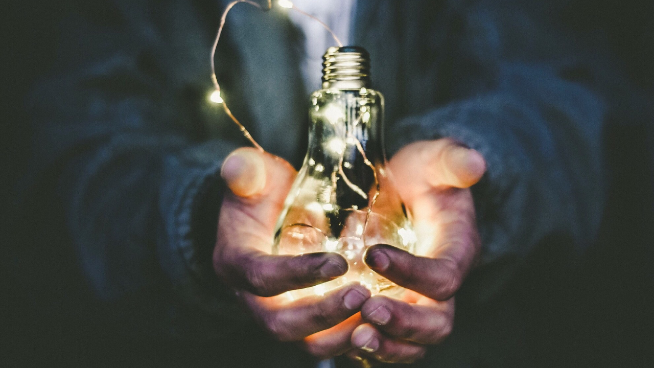 hands holding a light bulb