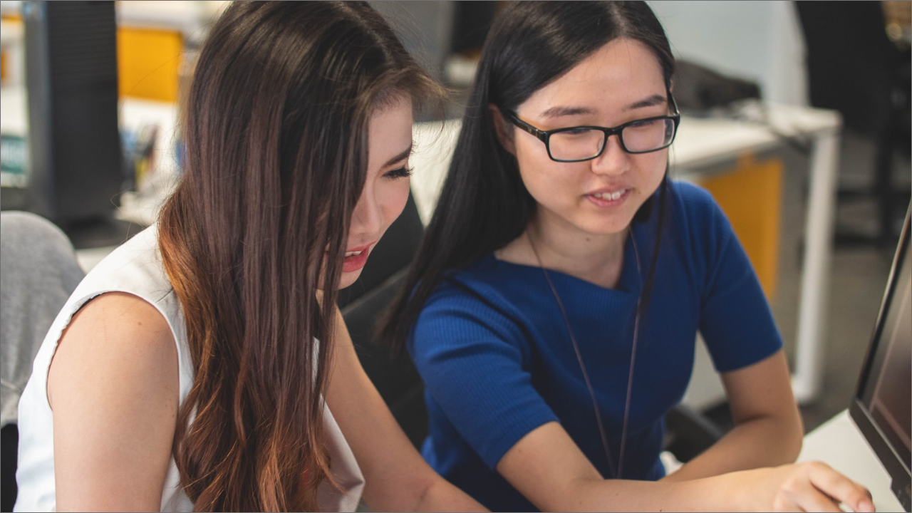 two ladies using a computer