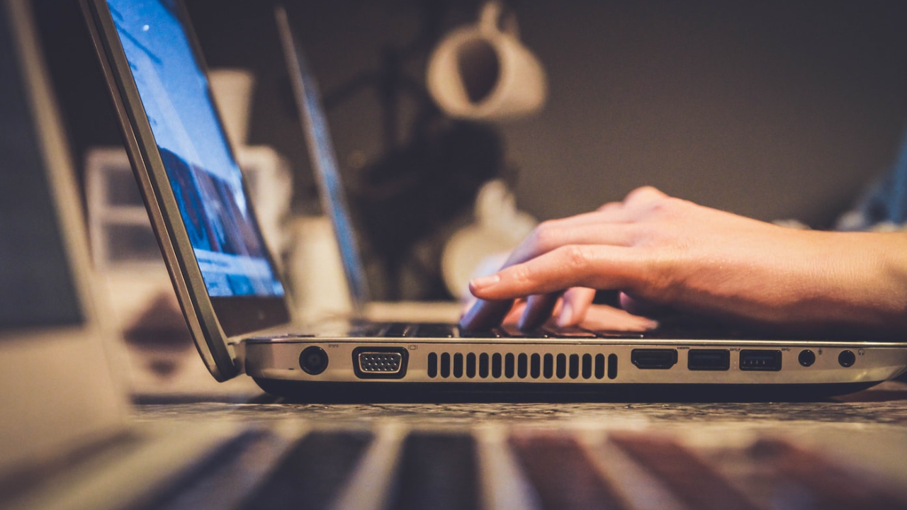 Someone typing on a laptop
