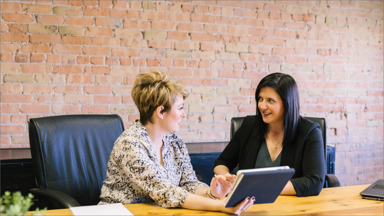 2 women talking in the conference room